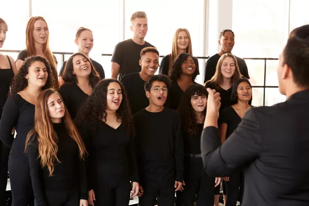 Teenage choir singing. Photo.