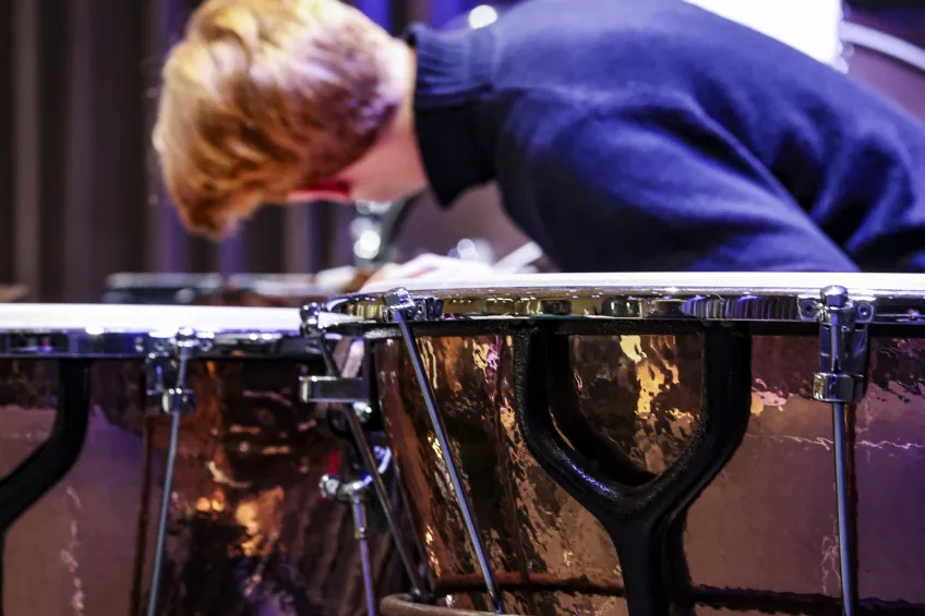 Student tuning timpani drums. Photographer: Michel Thomas. 